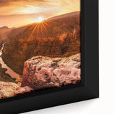 Framed canvas wall art showcasing a stunning landscape of cliffs at sunset, highlighting warm orange and purple hues with intricate detailing, perfect for home decor.