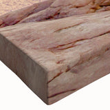 Close-up of a stretched canvas wall art featuring a vibrant landscape design with cliffs and blue skies, showcasing intricate textures and colors for home decor.