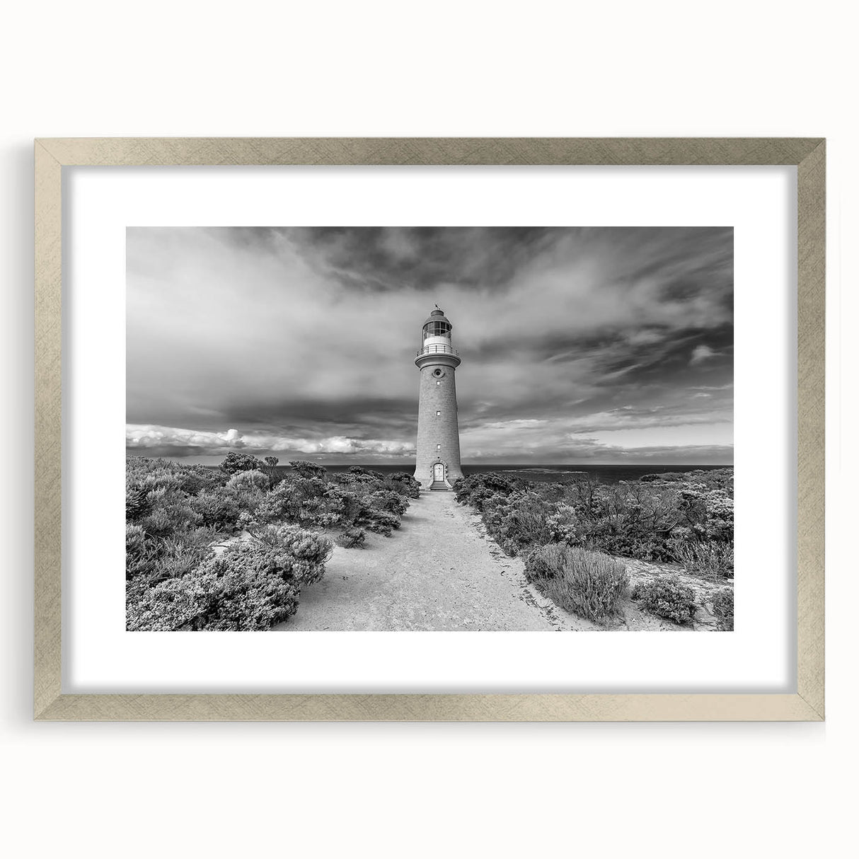 Framed landscape wall art featuring dramatic cliffs with a silver mat and frame, perfect for modern home decor. Elevate your living space with this stunning piece.