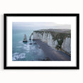 Framed landscape wall art showcasing dramatic cliffs in vibrant colors, featuring a sleek black frame with a white mat, perfect for modern home decor.