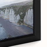 Close-up of a framed canvas wall art piece showcasing a stunning landscape with dramatic cliffs and vibrant colors, perfect for modern home decor.