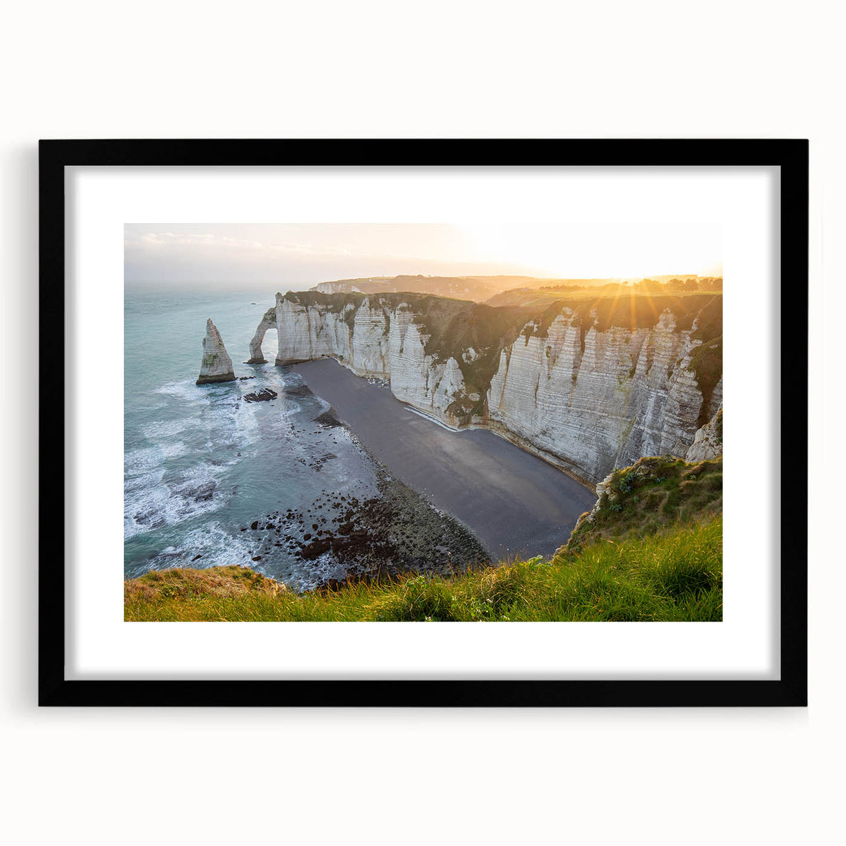 Framed wall art showcasing a dramatic cliff landscape in muted earth tones, presented in a sleek black frame with a white mat, perfect for modern decor.