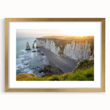 Framed wall art featuring a striking landscape of cliffs in earthy tones, accented by a gold mat, showcasing natural beauty and elegance in home decor.