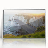 Framed acrylic wall art featuring a stunning landscape of rugged cliffs and serene ocean waves, presented in a sleek white frame, ideal for modern home decor.