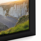 Framed canvas wall art showcasing a vibrant landscape of cliffs at sunset, featuring rich colors of orange, purple, and blue, perfect for home decor.