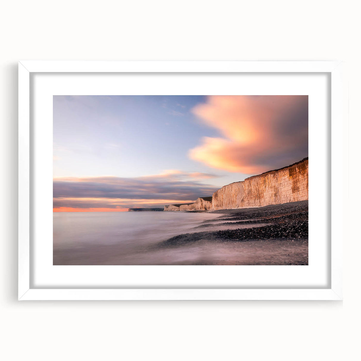 Framed wall art showcasing a stunning landscape of cliffs, featuring vibrant colors and rich textures, set in a sleek white frame with a mat, perfect for home decor.