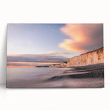Stretched canvas wall art showcasing a vibrant landscape with towering cliffs and a serene sky, perfect for home decor. The artwork adds a touch of nature to any room.