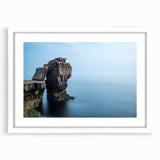 Framed landscape wall art featuring dramatic cliffs and vivid colors, presented with a white mat for a modern touch, perfect for home decor.
