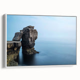 Framed canvas wall art showcasing a stunning landscape of cliffs in soft hues, elegantly displayed with a white frame, perfect for modern home decor.