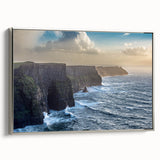 Framed canvas wall art showcasing a serene landscape with majestic cliffs and vibrant colors, set against a silver frame for an elegant touch. Perfect for home decor.