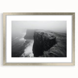 Framed wall art featuring a serene landscape of dramatic cliffs, accented with a silver mat and sleek frame, ideal for enhancing modern decor aesthetics.