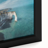 Close-up of a framed canvas wall art piece showcasing a vibrant landscape with cliffs, featuring rich colors and intricate details, perfect for home decor.