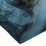 Close-up of a vibrant stretched canvas wall art featuring a dramatic landscape of cliffs, showcasing rich colors and intricate textures, ideal for modern home decor.