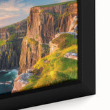 Close-up of a framed canvas wall art piece featuring a vibrant landscape with cliffs, showcasing rich colors and intricate details, perfect for home decor.