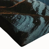 Close-up of a stretched canvas wall art piece showcasing vibrant landscapes and cliffs, emphasizing intricate textures and rich colors, perfect for home decor.