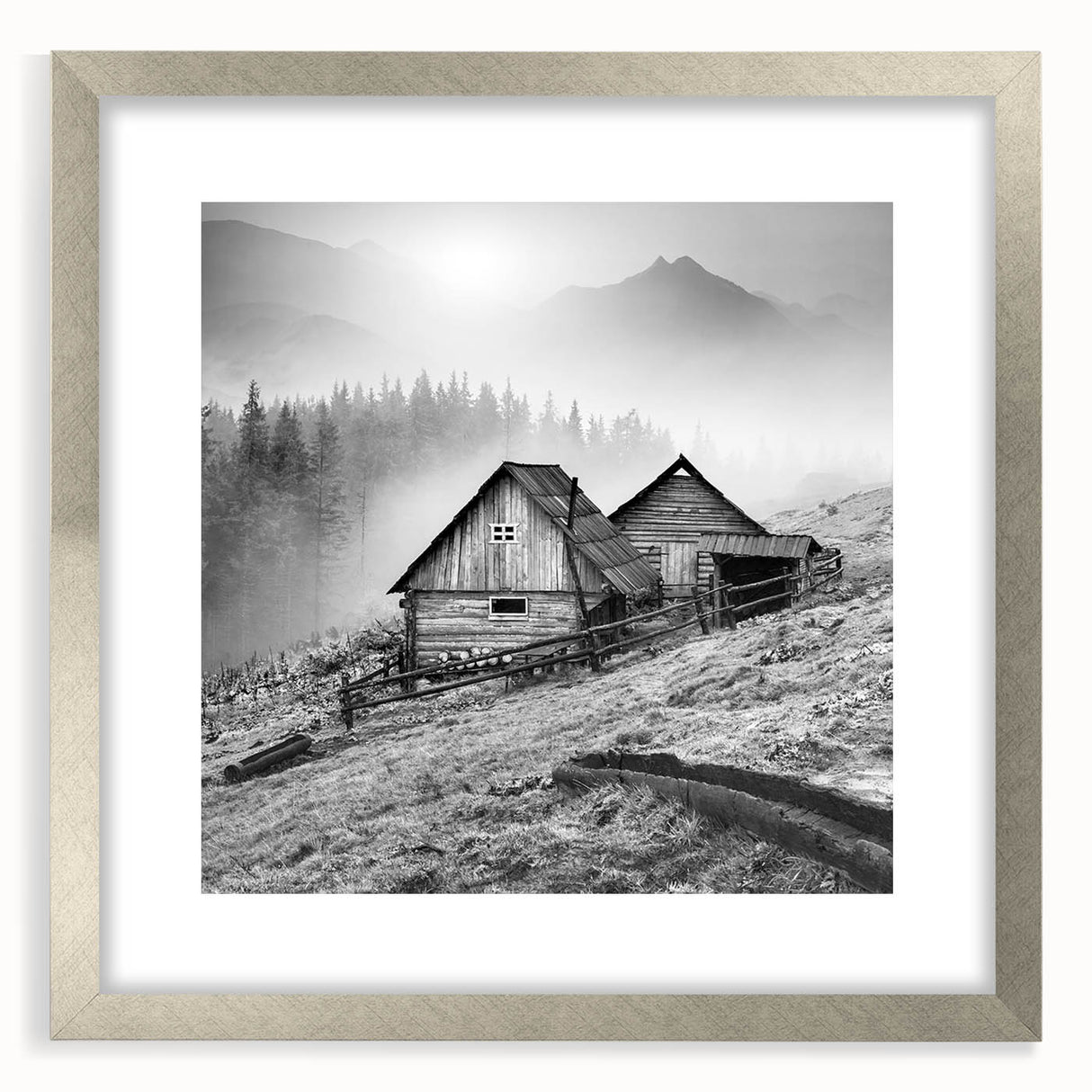 Framed wall art depicting a serene countryside landscape, featuring lush green fields and a vibrant sky, elegantly presented in a silver frame with a mat for a modern touch.