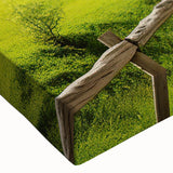 Vibrant close-up of a stretched canvas featuring a serene countryside landscape design, showcasing rich green fields and a clear blue sky, perfect for home decor.