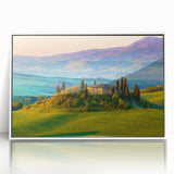 Framed acrylic wall art featuring a serene countryside landscape design, showcasing vibrant greens and blues, perfect for home decor. White frame complements the artwork.