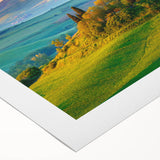Serene countryside landscape canvas print showcasing vibrant green fields and a clear blue sky, rolled and ready for display in a modern home decor setting.