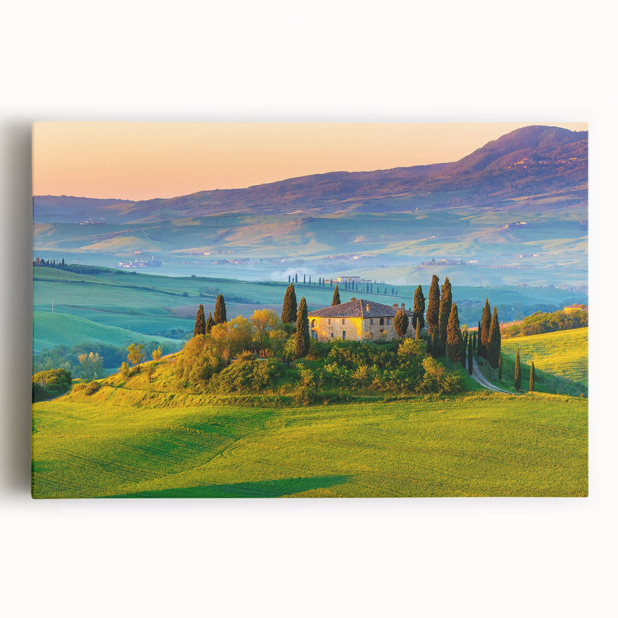 Stretched canvas wall art featuring a serene countryside landscape with rolling hills, vibrant greenery, and a clear blue sky, ideal for home decor.