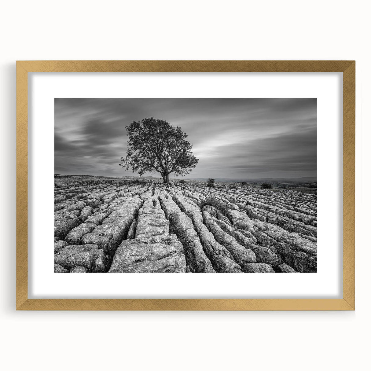 Framed wall art collection depicting a serene countryside landscape design, featuring a gold frame and mat, perfect for enhancing home decor and interior aesthetics.