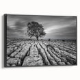 Framed canvas wall art showcasing a serene countryside landscape design, featuring vibrant greens and earthy tones, viewed from the side with a sleek black frame.
