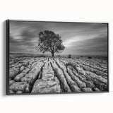Framed canvas wall art showcasing a serene countryside landscape design, featuring vibrant greens and earthy tones, viewed from the side with a sleek black frame.