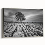 Framed canvas wall art of a serene countryside landscape, showcasing vibrant green fields and a clear blue sky, accented by a silver frame for added elegance. Perfect for home decor enthusiasts seeking a touch of nature-inspired design.