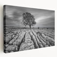 Stretched canvas wall art showcasing a serene countryside landscape with vibrant green fields and a clear blue sky, perfect for home decor.