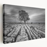 Stretched canvas wall art showcasing a serene countryside landscape with vibrant green fields and a clear blue sky, perfect for home decor.