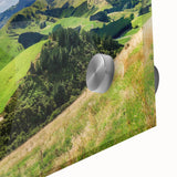 Close-up of a vibrant acrylic glass wall art piece showcasing a serene countryside landscape, highlighting lush green fields and a clear blue sky, perfect for home decor.