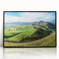 Framed acrylic wall art depicting a serene countryside landscape with lush green fields, vibrant blue sky, and subtle textures, perfect for home decor enhancement.