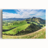 Vibrant stretched canvas wall art depicting a serene countryside landscape with rolling hills and lush greenery, perfect for home decor and artistic ambiance.