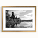 Framed wall art of a serene countryside landscape, featuring lush green fields and a blue sky, elegantly displayed with a gold mat, perfect for home decor.