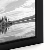 Close-up of a framed canvas wall art piece depicting a serene countryside landscape with lush green fields, vibrant wildflowers, and a soft blue sky, ideal for home decor.