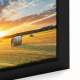 Close-up of a framed canvas art piece depicting a serene countryside landscape with vibrant green fields, rolling hills, and a clear blue sky, perfect for home decor.