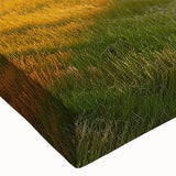 Close-up of a stretched canvas featuring a serene countryside landscape wall art design, highlighting vibrant green fields and a tranquil blue sky, ideal for home decor.