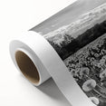 Rolled canvas artwork showcasing a serene countryside landscape with vibrant green fields and a clear blue sky, elegantly packaged in a protective cardboard tube.