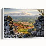 Framed canvas wall art showcasing a serene countryside landscape with lush greenery and rolling hills, displayed with a white frame from a side view, perfect for home decor.