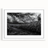 Framed wall art featuring a serene countryside landscape with rolling hills and a vibrant sunset, showcased in a sleek white mat and frame, perfect for home decor.