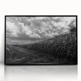 Framed wall art featuring a serene countryside landscape design with vibrant green fields and a clear blue sky, presented in a sleek black frame for modern decor.