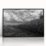 Framed wall art featuring a serene countryside landscape design with vibrant green fields and a clear blue sky, presented in a sleek black frame for modern decor.