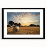 Black-framed wall art featuring a serene countryside landscape design, showcasing vibrant greens and blues, suitable for home decor or office environments.