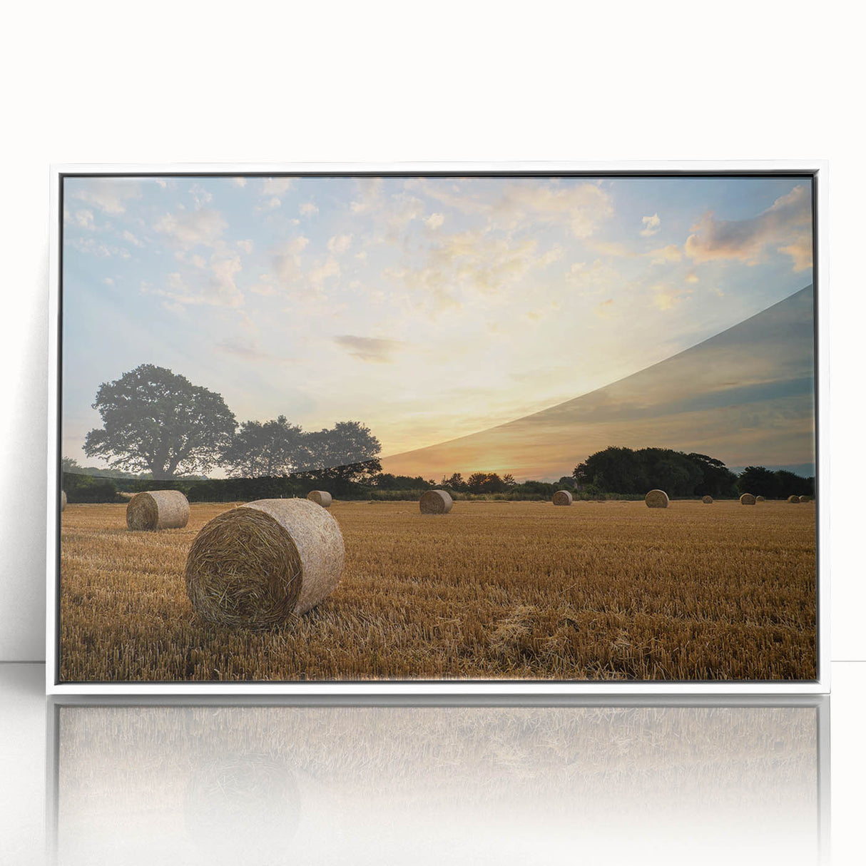 Framed wall art featuring a serene countryside landscape with lush green fields and a bright blue sky, designed for home decor in a modern white frame.
