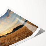 Vibrant rolled print showcasing a serene countryside landscape with rolling hills and a colorful sunset, ideal for home decor or art collection.