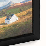 Close-up of a framed canvas wall art piece showcasing a vibrant countryside landscape design with lush greenery and a serene sky, perfect for home decor.