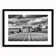 Framed wall art showcasing a serene countryside landscape with vibrant green fields and a striking blue sky. The black frame enhances the artwork's elegance, making it a perfect home decor piece.