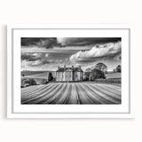 Framed wall art print featuring a serene countryside landscape, showcasing rolling hills and a vibrant sunset, presented in a white mat for an elegant display.