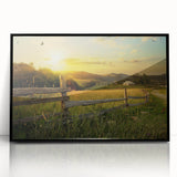 Framed acrylic wall art featuring a serene countryside landscape with rolling hills, greenery, and a tranquil sky, presented in a sleek black frame for modern decor.