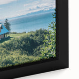 Close-up of a beautifully framed canvas wall art piece depicting a serene countryside landscape with vibrant green fields and a blue sky, ideal for home decor.